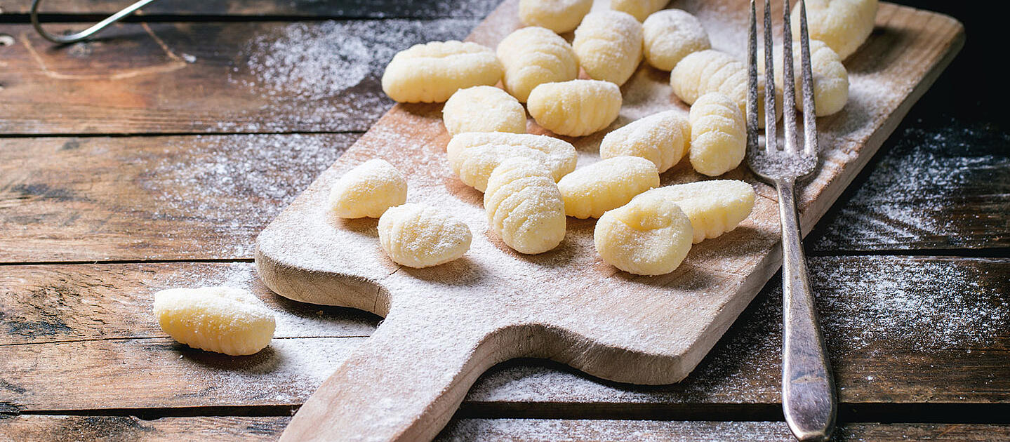 Gnocchi on a wooden board.